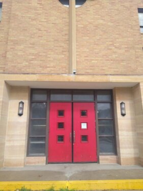 Two red doors at the entrance of Great Is Thy Faithfulness