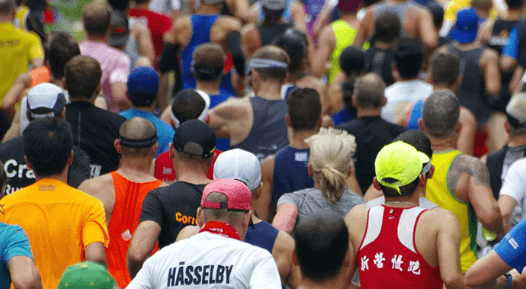 Runners running a race in a large crowd